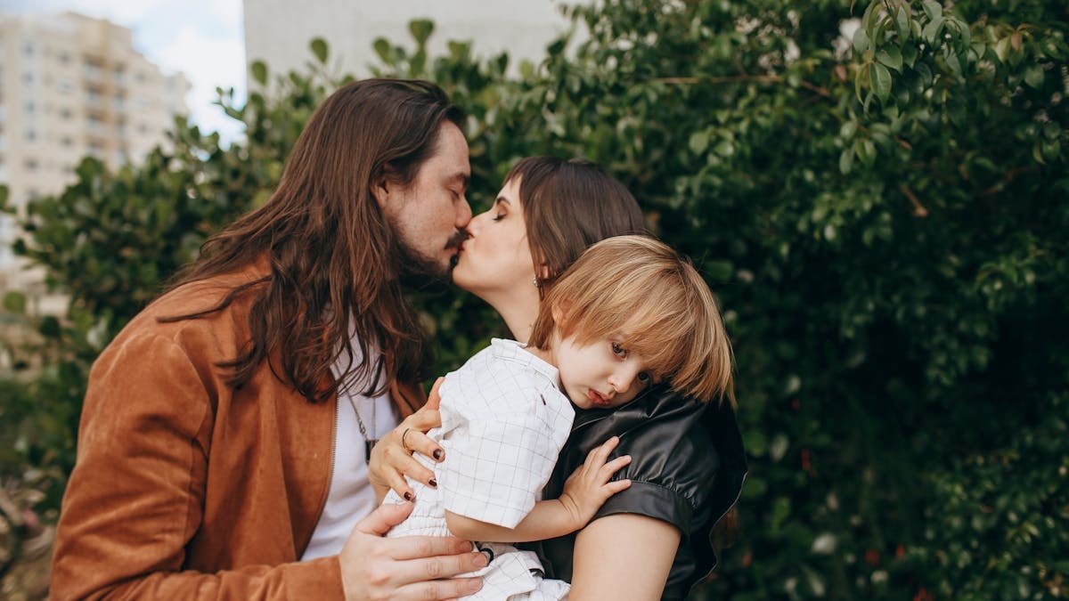 Loving family sharing an intimate moment outdoors, highlighting connection and warmth.